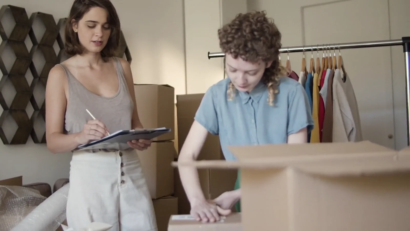 A shop team preparing a parcel for shipping.